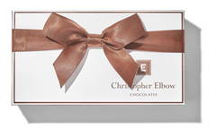 A beautifully wrapped Christopher Elbow  gift box filled with an assortment of delicious chocolates