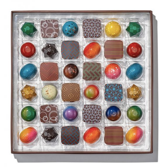 Luxurious box of 36 Christopher Elbow bonbons, showcasing a wide variety of gourmet chocolate flavors for an indulgent treat.