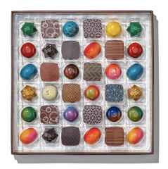 Luxurious box of 36 Christopher Elbow bonbons, showcasing a wide variety of gourmet chocolate flavors for an indulgent treat.